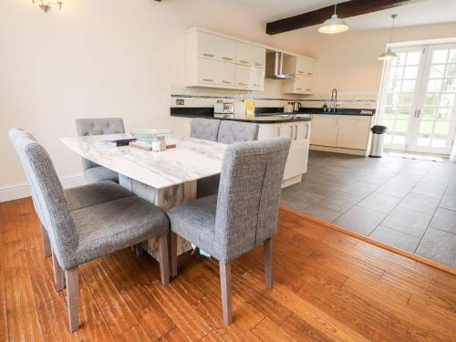 a kitchen with a wooden table and chairs in a room at Hudson in Lancaster