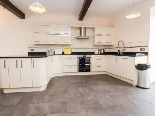 a kitchen with white cabinets and black counter tops at Hudson in Lancaster