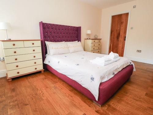 a bedroom with a large bed and a wooden floor at Hudson in Lancaster
