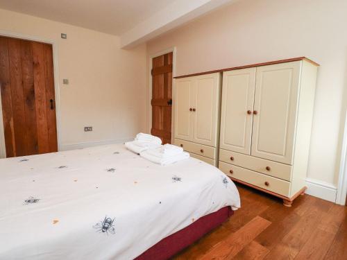 a bedroom with a large bed and a cabinet at Hudson in Lancaster