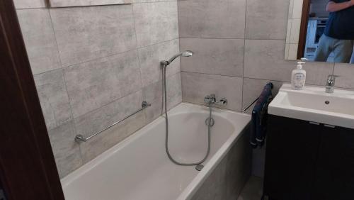 a bathroom with a bath tub and a sink at Nocleg u Kasi nad Morzem Trójmiasto in Kowale