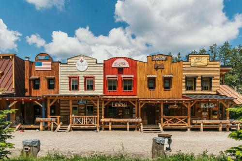 a group of wooden buildings sitting next to each other at Ranch 13 - Western a kone in Nemšová