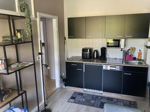 a kitchen with a sink and a counter top at Time-Out Westerbauer TH19 in Hagen