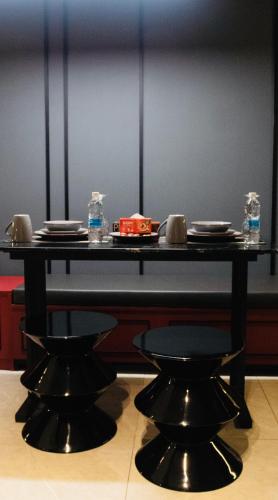 a table with plates and glasses on top of it at Axon Residence KLCC - KL HOME in Kuala Lumpur