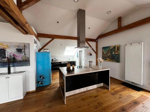 a kitchen with a island in the middle of a room at Loft am Teufelsberg in Burrweiler