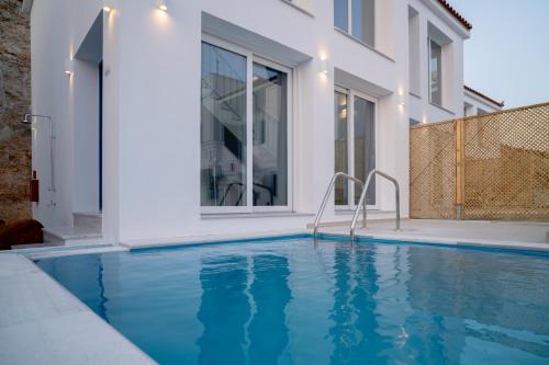 a swimming pool in front of a house at Kontemare Seascape in Koumeika