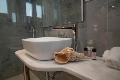 a white sink on a counter in a bathroom at Kontemare Seascape in Koumeika
