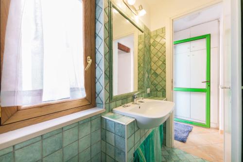 a bathroom with a sink and a mirror at Corricella Hammok - Gioia Apartments in Procida