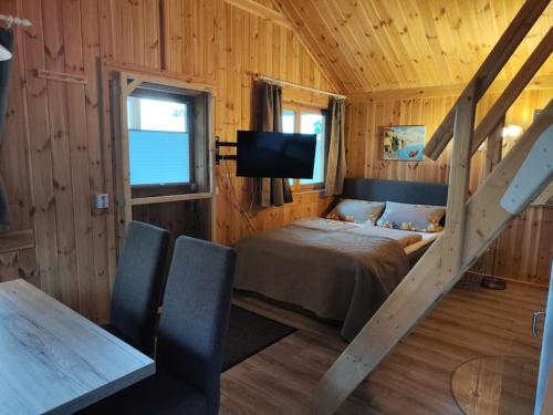 a bedroom with a bed and a tv in a room at Ferienwohnung Erlebnisfarm John in Sayda