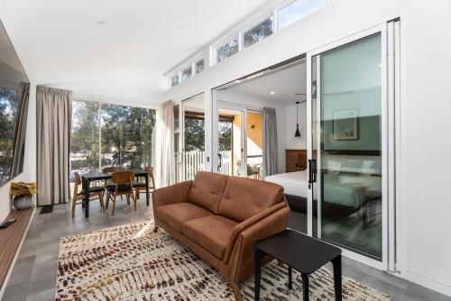 a living room with a couch and a bedroom at Clare Hillside Apartments in Clare