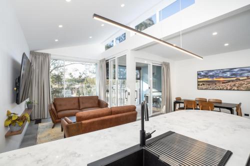 a kitchen and living room with a couch and a table at Clare Hillside Apartments in Clare