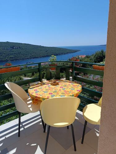a table and chairs on a balcony with a view at Bigova Bay Apartments in Bigovo
