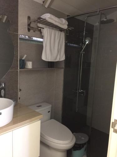バオロクにあるBING BONG HOTELのトイレとガラスのシャワー付きのバスルーム