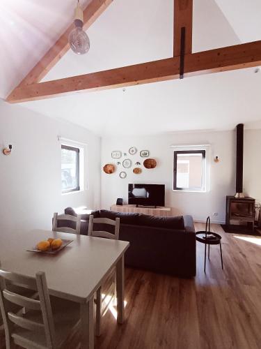 a living room with a table and a couch at Casa dos Matos in Ponte de Lima