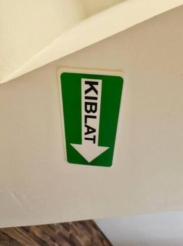 a green and white sign on a wall at Encorp Strand Suite by Luvit Stay in Petaling Jaya