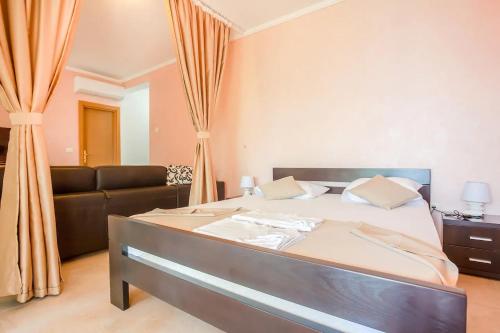 a bedroom with a bed and a couch at Apartment Moreta - Konoba More in Pržno