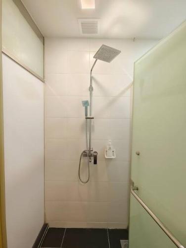 a bathroom with a shower with a glass door at Encorp Strand Suite by Luvit Stay in Petaling Jaya