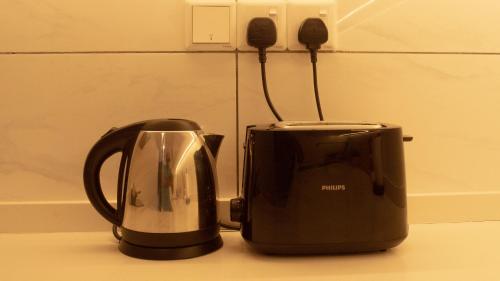 a toaster and a toaster sitting on a counter at Axon Residence KLCC - KL HOME in Kuala Lumpur