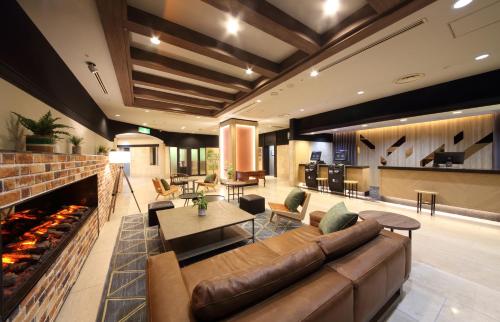 a living room with a couch and a fireplace at Takasaki Washington Hotel Plaza in Takasaki