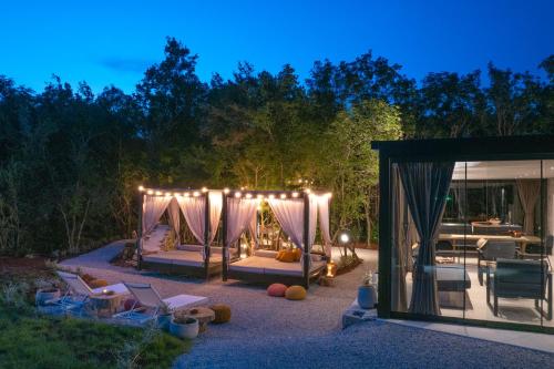 a backyard with a tent and chairs and a table at Casa al Lavere' in Bale