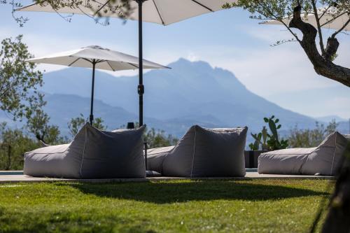 a group of pillows on the grass with an umbrella at Casa Plenilia in Pianella