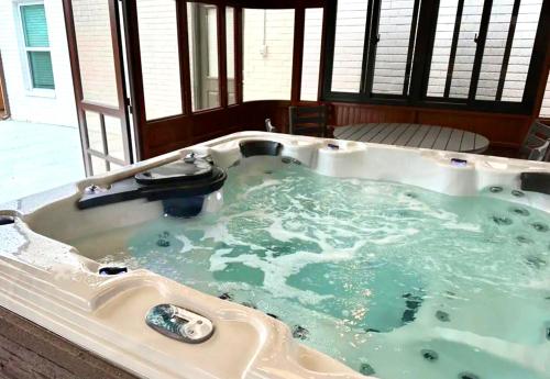 a jacuzzi tub with green water in it at 5BR Home 3 mins Wiley Post, Sleeps 12 #CO in Bethany