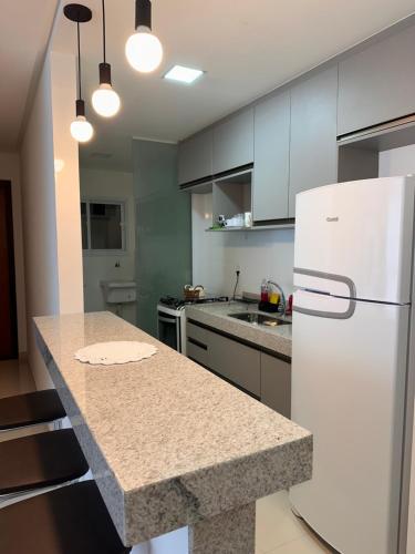 a kitchen with a white refrigerator and a counter at Meu cantinho nas Montanhas in Domingos Martins