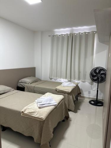 a room with three beds and a window at Meu cantinho nas Montanhas in Domingos Martins