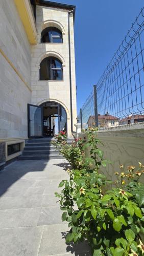 a building with a fence and flowers in front of it at İncebey Konak Cappadocia in Uçhisar