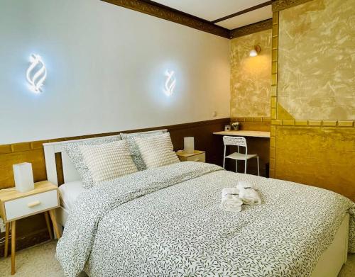 a bedroom with a bed with a stuffed animal on it at Maison Familiale avec Jardin in Ozoir-la-Ferrière