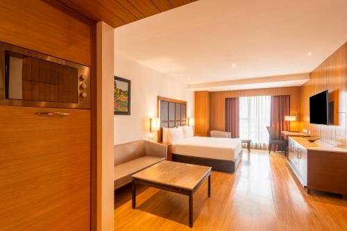 a hotel room with a bed and a couch at Svelte Delhi, a member of Radisson Individuals in New Delhi