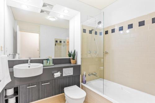 a bathroom with a toilet and a sink and a shower at Apartment with City Views in East Perth in Perth
