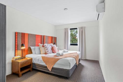 a bedroom with a large bed and a window at Apartment with City Views in East Perth in Perth