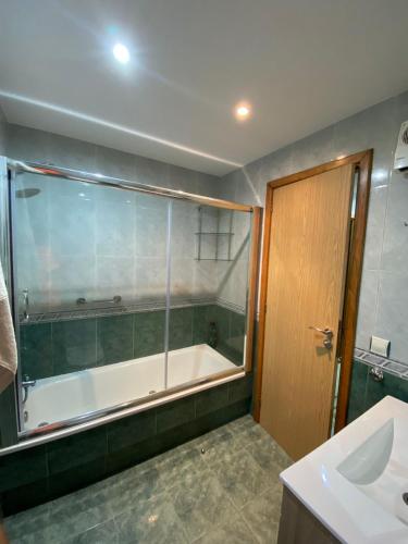 a bathroom with a tub and a sink at Carballeira in Moraña