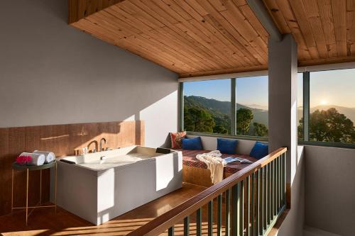 a house with a bath tub on a balcony at Storii By ITC Hotels, The Kaba Retreat, Solan in Solan
