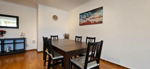 a dining room with a wooden table and chairs at Modern 3 Bed Flat - Beaches, Expo & City Fun - Your Gateway to Lisbon in Montijo