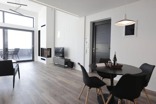 a dining room and living room with a table and chairs at Skiti Villas Green Holidays in Skíti