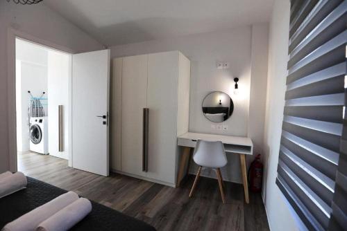 a bedroom with a dressing table and a mirror at Skiti Villas Green Holidays in Skíti