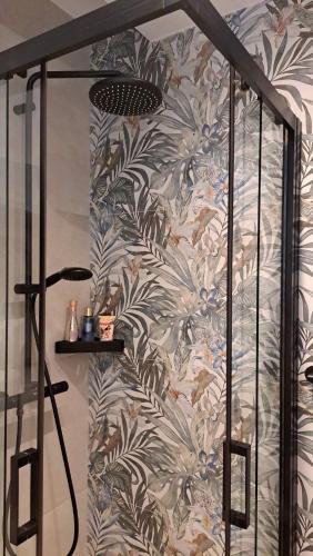 a shower in a bathroom with a wall at Room with jungle bathroom in Dubrovnik