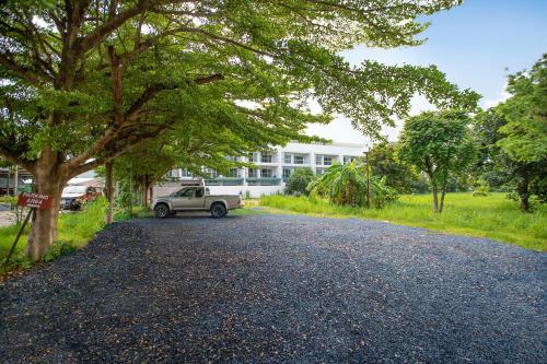 a car parked on a road in front of a building at Nariya Bayfront Phuket in Ban Bang Chak
