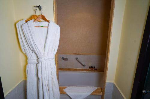 a bathroom with a shower curtain and a tub at Hotel Andalucia Tangier in Tangier