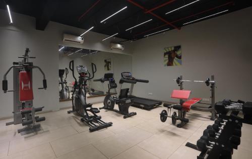 a gym with many exercise equipment in a room at juSTa Rudra Resort & Spa in Kolād
