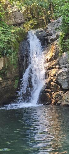 a waterfall on the side of a body of water at Agriturismo U' Spigu Nonna Annetta in Nasino