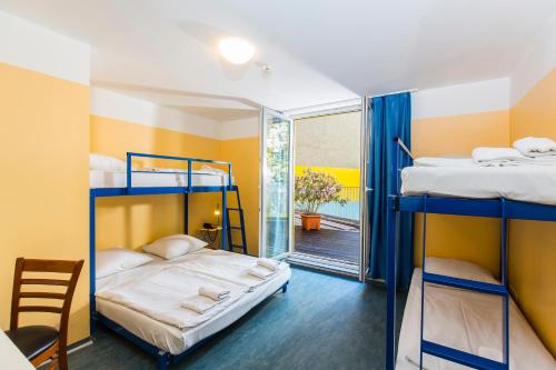 a room with two bunk beds and a balcony at Pegasus Hostel Berlin in Berlin