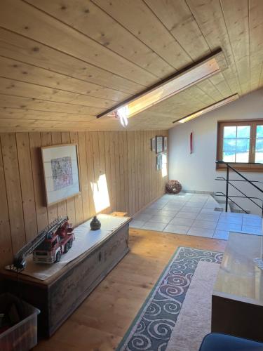 a large room with a wooden ceiling with a toy truck in it at Casa Runs 7113 Camuns, Val Lumnezia in Uors