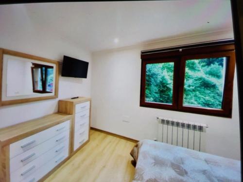 a bedroom with a bed and a window at Casa aparicio in Cudillero