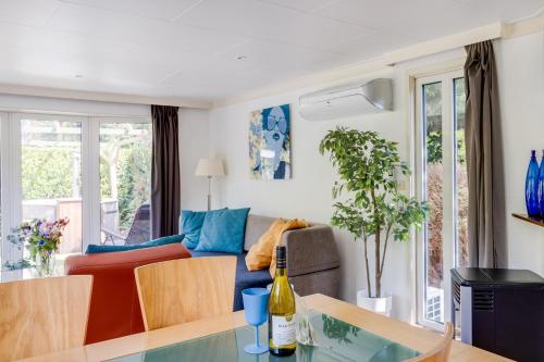 a living room with a couch and a table at GREAT STAY - NATURE - Outside HOTTUB en SAUNA in Voorthuizen