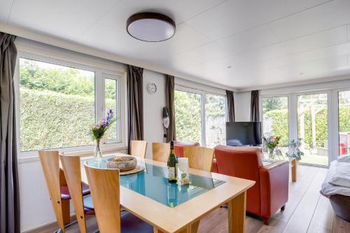 a dining room with a table and chairs at GREAT STAY - NATURE - Outside HOTTUB en SAUNA in Voorthuizen