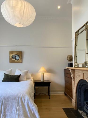 a bedroom with a bed and a mirror at Eyre House Ballarat in Wendouree