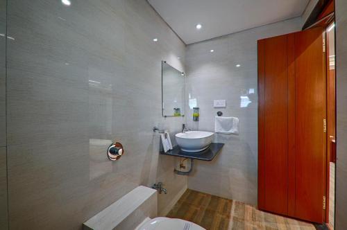 a bathroom with a sink and a toilet at HOTEL SHITAL INN in Ahmedabad